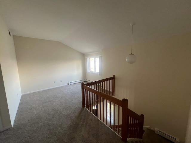 interior space featuring lofted ceiling, carpet floors, and a baseboard heating unit