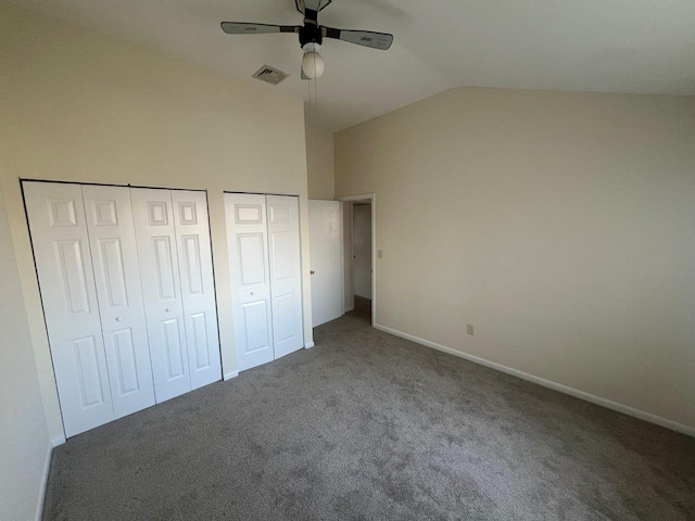 unfurnished bedroom featuring multiple closets, ceiling fan, high vaulted ceiling, and dark colored carpet