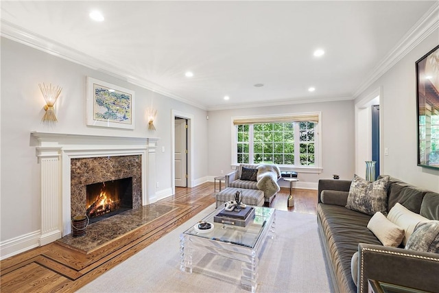 living room with hardwood / wood-style flooring, crown molding, and a premium fireplace