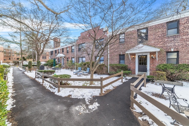 view of front facade featuring brick siding and a residential view