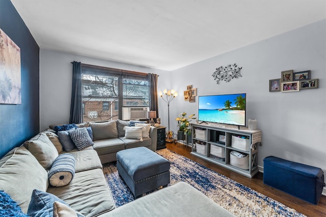 living area featuring dark wood-type flooring and baseboards