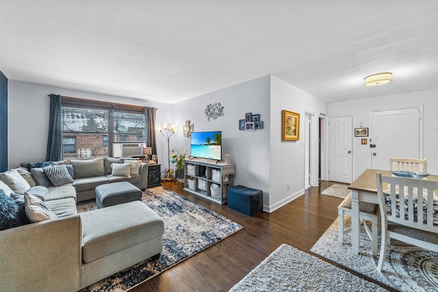 living area featuring dark wood-type flooring, cooling unit, and baseboards