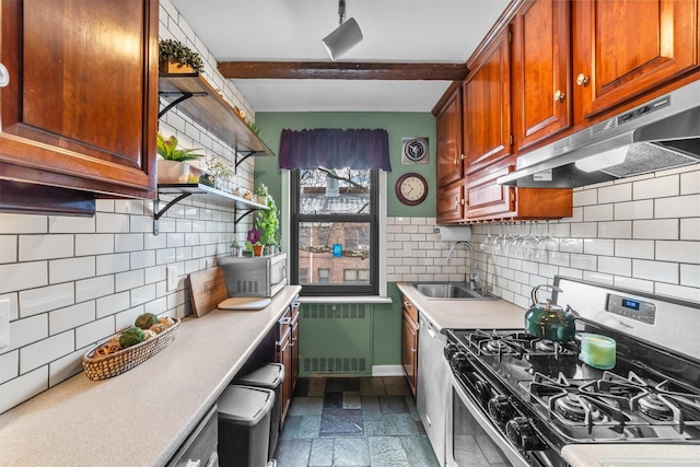 kitchen featuring light countertops, radiator heating unit, appliances with stainless steel finishes, a sink, and under cabinet range hood