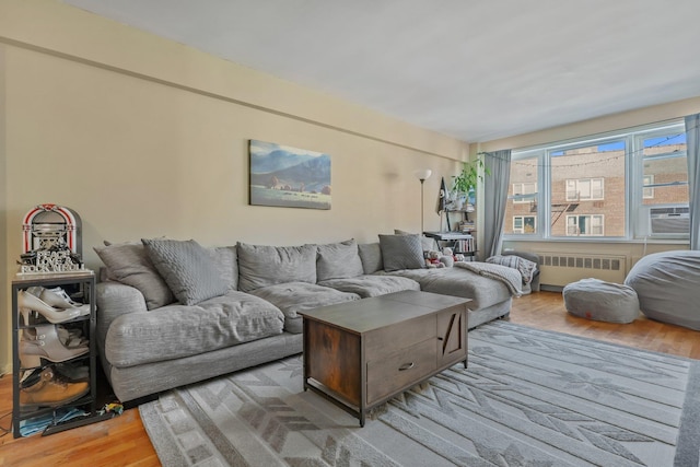 living room with radiator and light hardwood / wood-style flooring