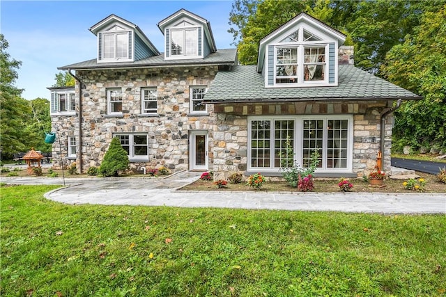 rear view of property featuring a yard