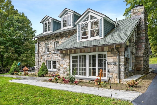 rear view of property with a yard