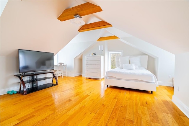 bedroom featuring vaulted ceiling and light hardwood / wood-style flooring