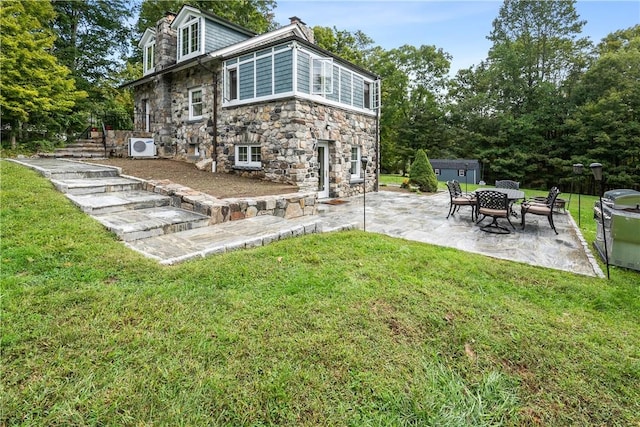 exterior space with a shed, ac unit, a lawn, and a patio