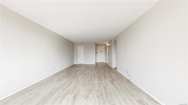 spare room featuring light wood-type flooring