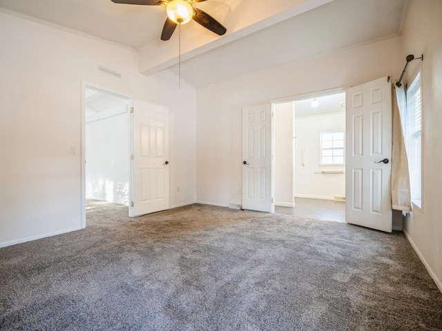 carpeted spare room featuring ceiling fan, ornamental molding, and beam ceiling