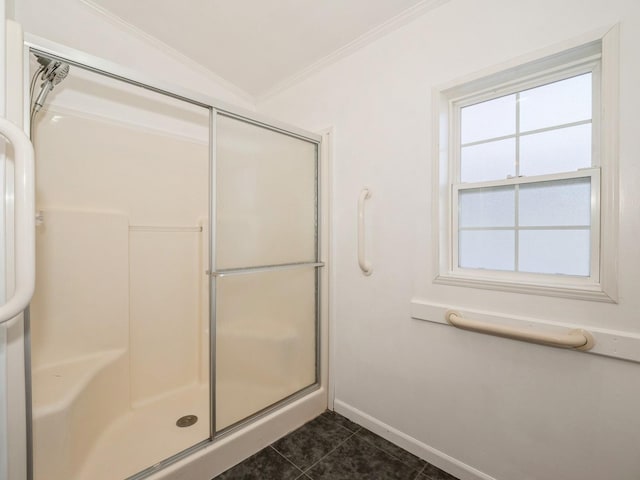 bathroom featuring tile patterned flooring, ornamental molding, and a shower with door