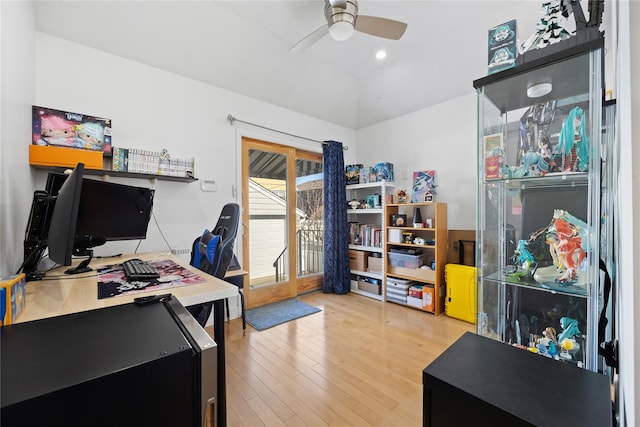 office space featuring ceiling fan, lofted ceiling, and hardwood / wood-style floors