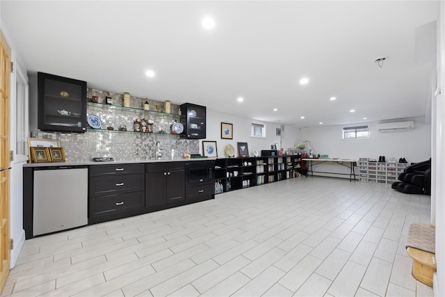 bar with backsplash, a wall unit AC, sink, and refrigerator