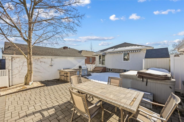 view of patio / terrace with a hot tub