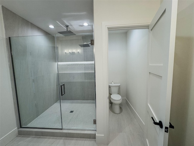 bathroom featuring an enclosed shower and toilet