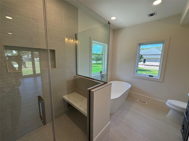 2045 Willow Dr, East Marion, NY 11939 - full bathroom with healthy amount of natural light, a freestanding tub, a stall shower, toilet, and recessed lighting