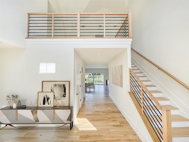 2045 Willow Dr, East Marion, NY 11939 - corridor with wood finished floors, stairway, baseboards, and a towering ceiling