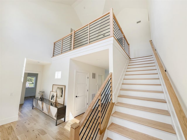 2045 Willow Dr, East Marion, NY 11939 - stairs featuring a high ceiling, wood finished floors, and baseboards