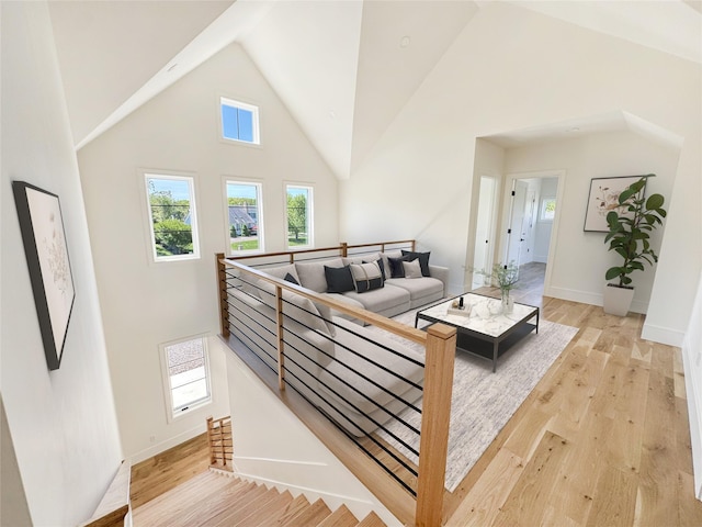 2045 Willow Dr, East Marion, NY 11939 - living room with high vaulted ceiling, light wood-type flooring, and baseboards