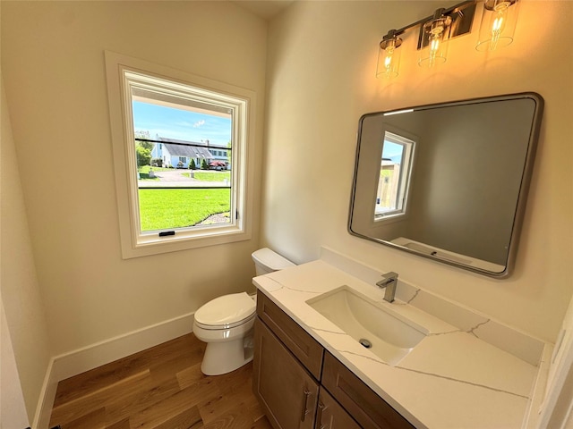 2045 Willow Dr, East Marion, NY 11939 - half bath with wood finished floors, vanity, baseboards, and toilet