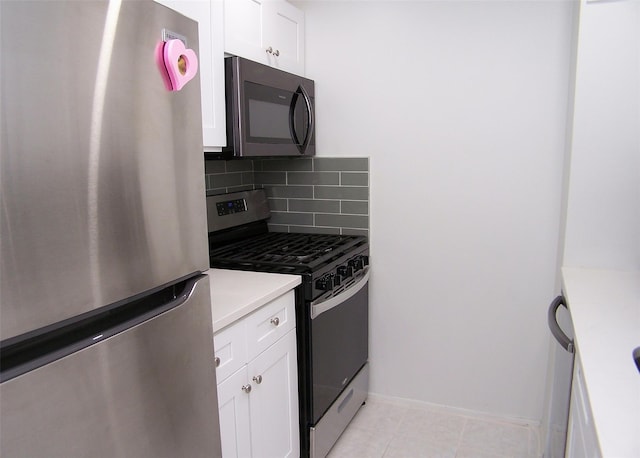 kitchen with white cabinetry, light tile patterned floors, decorative backsplash, and appliances with stainless steel finishes