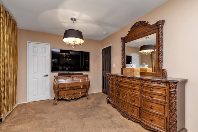 carpeted bedroom with a notable chandelier