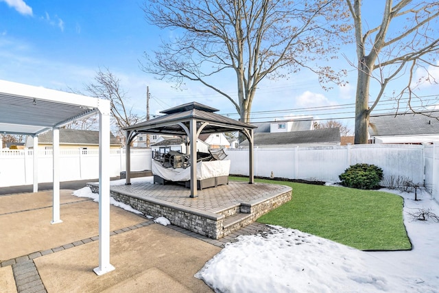 wooden terrace with a gazebo, a patio area, and a lawn