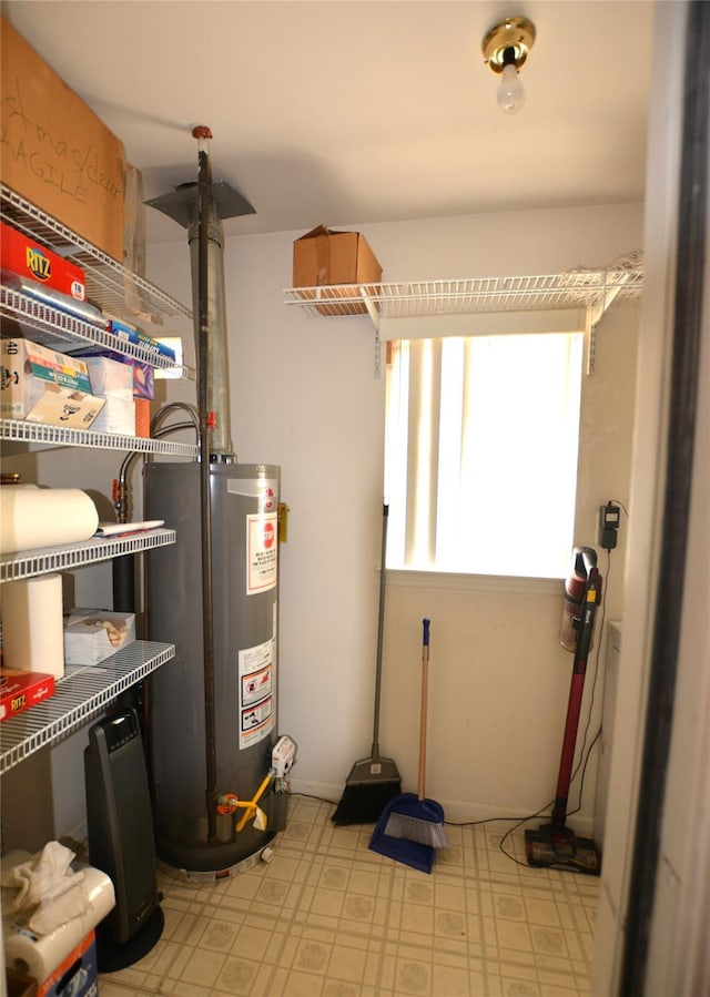 utility room with gas water heater