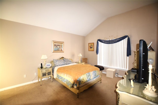 bedroom with vaulted ceiling and carpet floors