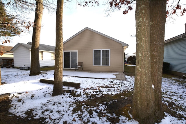 view of snow covered back of property