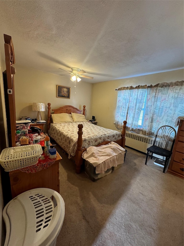 bedroom featuring carpet floors, a textured ceiling, and ceiling fan