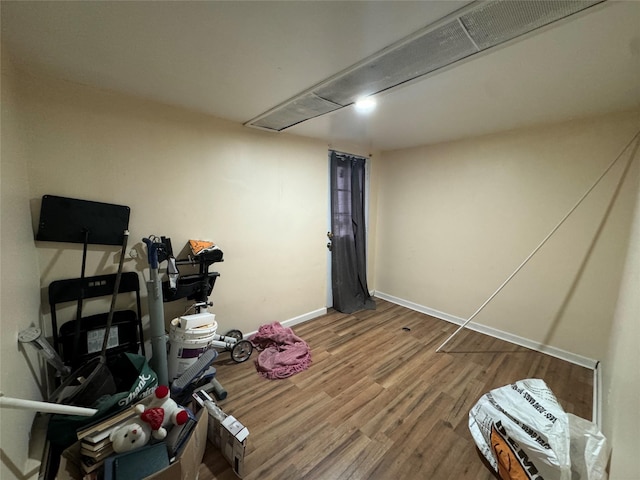 interior space featuring baseboards and wood finished floors