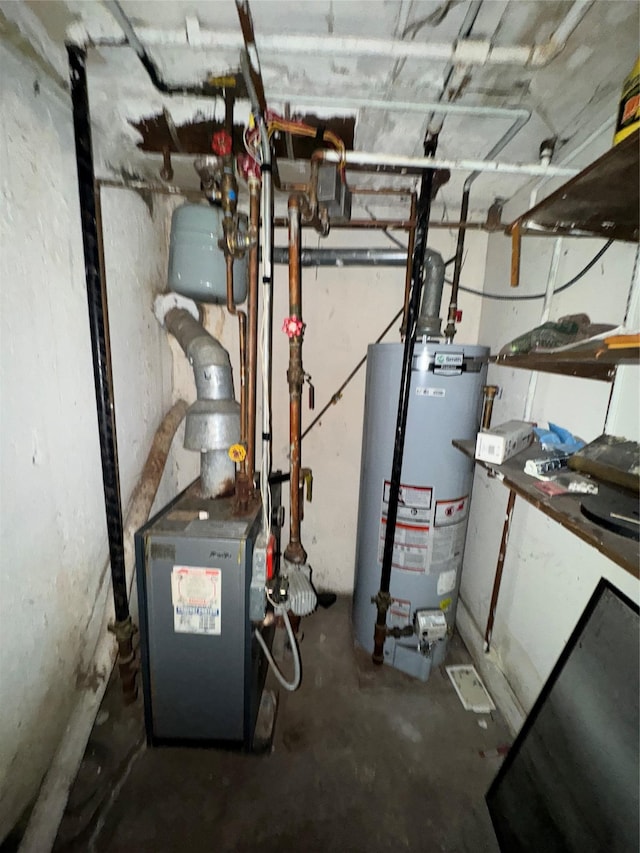 utility room featuring gas water heater and a heating unit