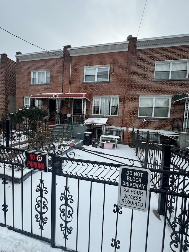 exterior space featuring brick siding and a fenced front yard