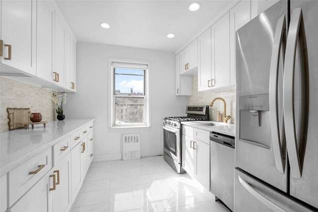 kitchen with white cabinetry, sink, decorative backsplash, and appliances with stainless steel finishes