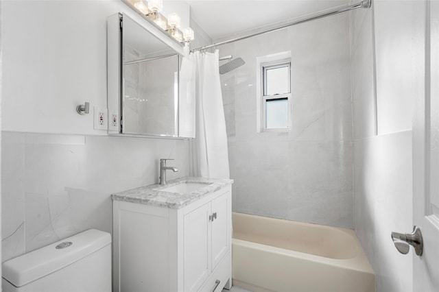 full bathroom with vanity, tile walls, shower / bath combo, and toilet