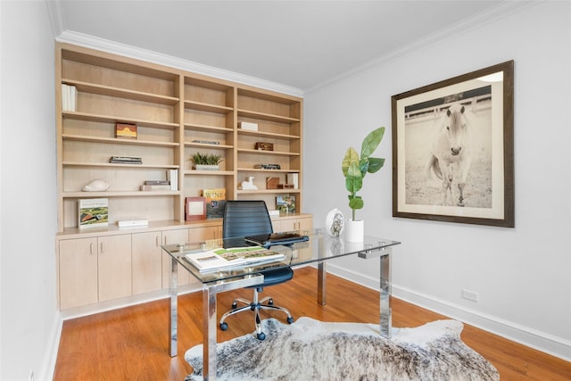 office featuring light wood finished floors, baseboards, and ornamental molding