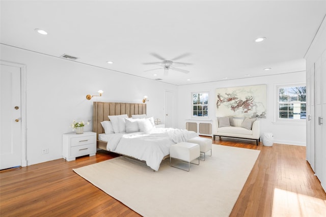 bedroom featuring light wood-type flooring, visible vents, and recessed lighting