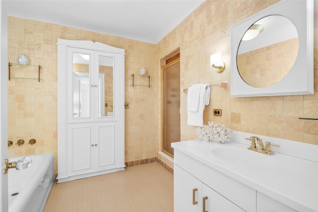 full bathroom featuring a garden tub, tile walls, and vanity