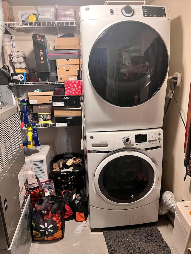 clothes washing area with stacked washer / dryer