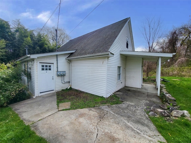 rear view of property with a carport