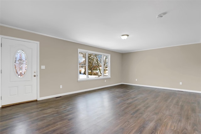 entrance foyer featuring ornamental molding and dark hardwood / wood-style floors