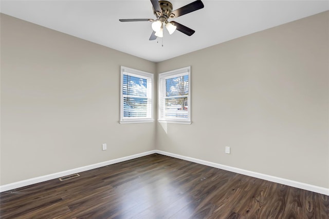 unfurnished room with dark hardwood / wood-style floors and ceiling fan