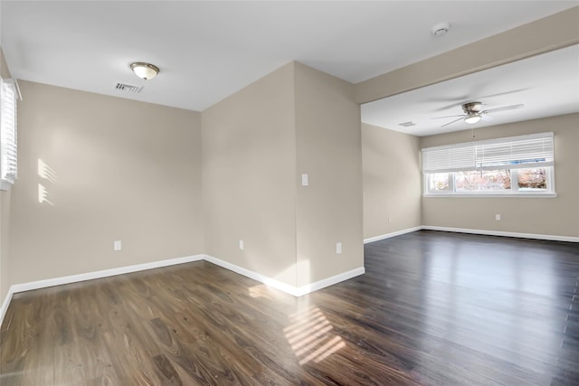 unfurnished room with ceiling fan and dark hardwood / wood-style flooring