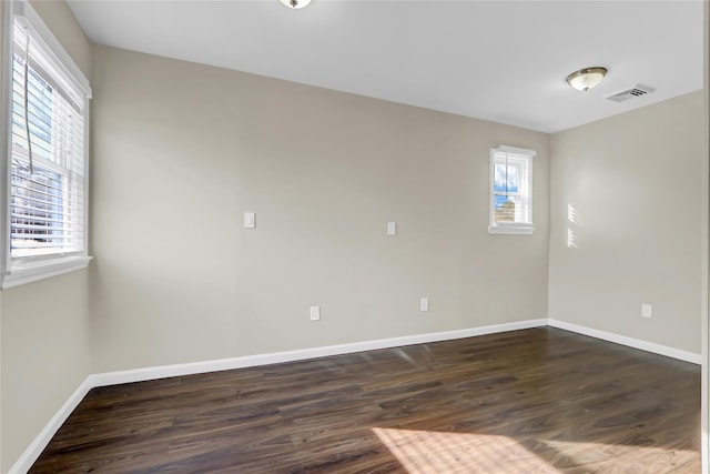 empty room with dark hardwood / wood-style floors