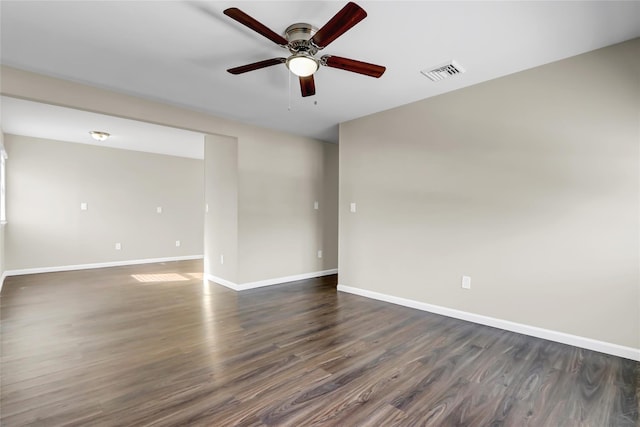 empty room featuring dark hardwood / wood-style flooring and ceiling fan