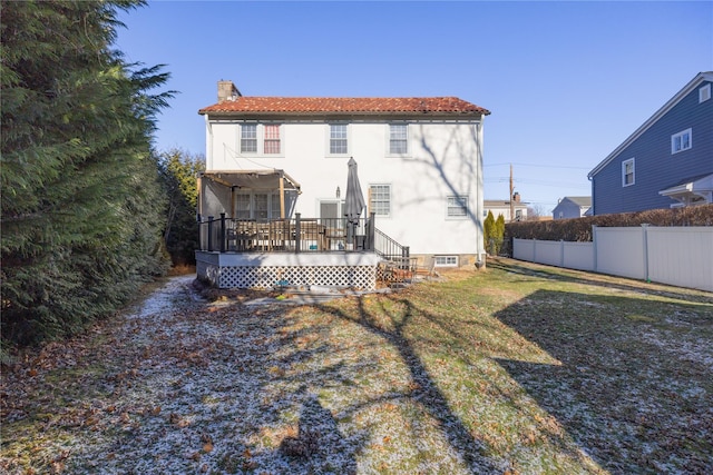 back of house with a yard and a deck