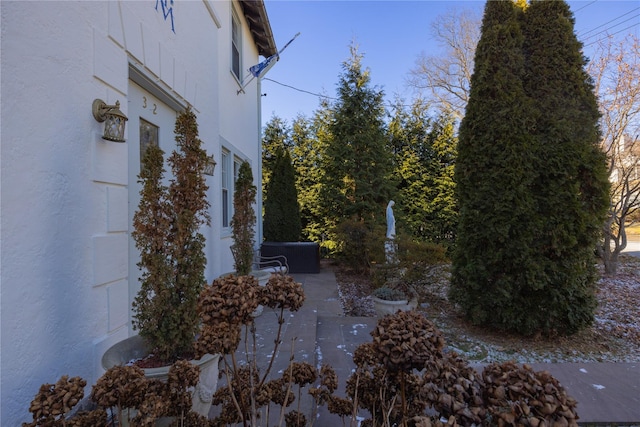 view of side of home with a patio area