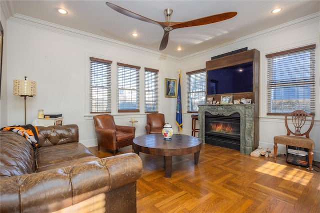 living room with parquet flooring, ornamental molding, and ceiling fan