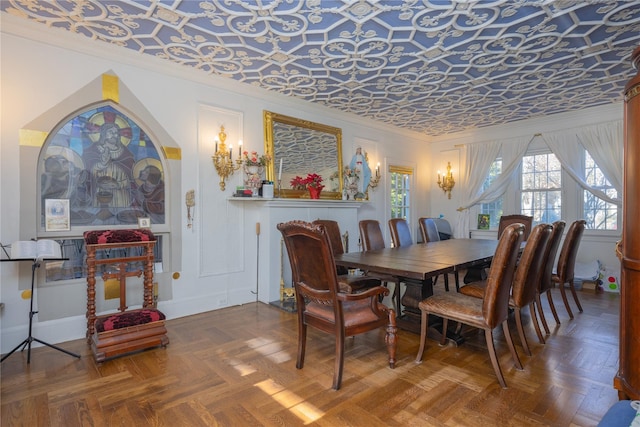 dining room featuring crown molding and parquet flooring